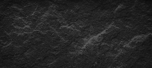 Dark gray black slate stone background or texture, horizontal shape with space for design. Web banner. Wide. Panoramic. Website header