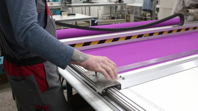 Roller blind cutting machine. The process of creating blinds. Factory