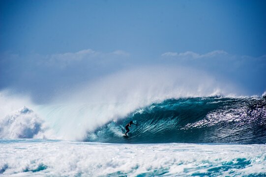 Surfer navigates pipeline wave