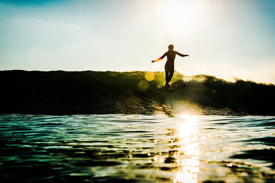 Surfer Nose-riding into the sunset