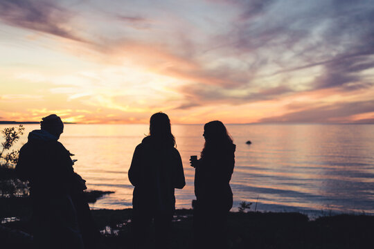 Silhouette Of A Group Of Friends Talking And Drinking On The Georgian Bay