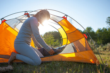 Woman setting up tent