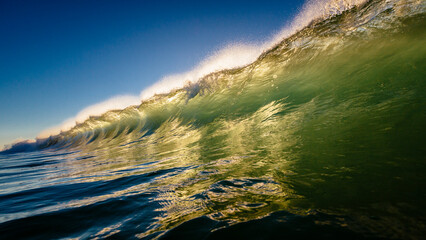 A wave breaks near shore at Sunrise Beach, Queensland, Australia.