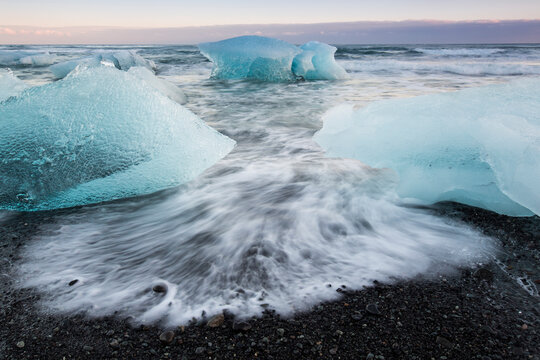 Glacial ice from Brei&Atilde;&deg;amerkurj&Atilde;&para;kull sits on the beach  of the coast at Brei&Atilde;&deg;amerkursandur, Iceland, also known as the Jokulsarlon.