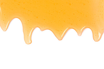 Dripping honey flows on white background with copyspace