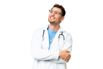 Brazilian doctor man over isolated chroma key background looking up while smiling