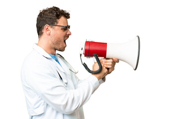 Brazilian doctor man over isolated chroma key background shouting through a megaphone