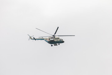 Mil Mi-17 military Russian helicopter flies in cloudy sky