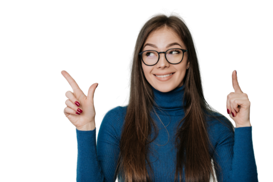 Pretty caucasian woman in blue sweater at studio over transparent background in glasses, looking up, pointing up with both hand by index fingers. Look up, mockup. Level up concept, growing, sale.