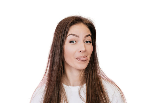 Don’t worry, be happy! Close up of attractive young woman with loose hair showing tongue, having fun against transparent background. Happy people concept. Let’s play. Cheerful Italian female fooling