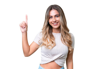 Fototapeta premium Young Uruguayan woman over isolated background pointing up a great idea