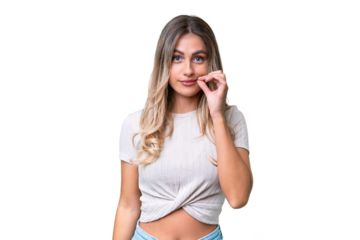 Young Uruguayan woman over isolated background showing a sign of silence gesture