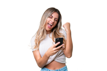 Young Uruguayan woman over isolated background with phone in victory position