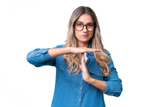 Young Uruguayan woman over isolated background making time out gesture