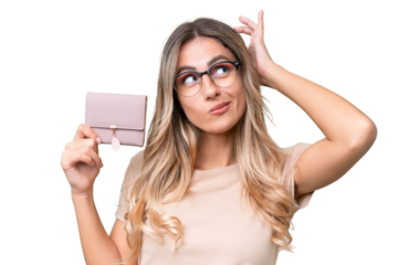 Young Uruguayan woman holding a wallet over isolated background having doubts and with confuse face expression