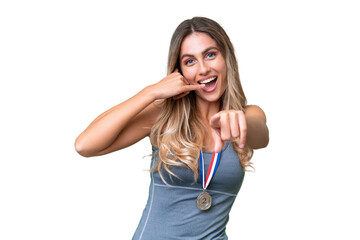 Young pretty sport Uruguayan woman with medals over isolated background making phone gesture and pointing front