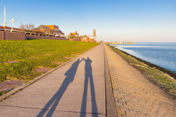 Shadow of a couple holding hands on the dike in Wilhelmshaven, Germany