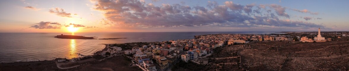Obraz premium Aerial drone. Rocky coastline and island at Portopalo di Capo Passero, Siracusa Province, Sicily.