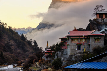 Mountain peaks and sunset light surround a Himalayan village