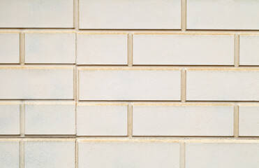 Decorative beige brickwork finishing panels, background wallpaper, uniform texture pattern