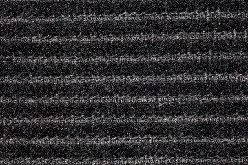 Corduroy black fabric with furrows horizontally, background wallpaper, uniform texture pattern