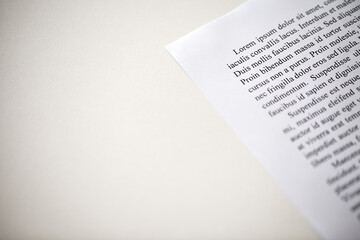 Lorem Ipsum text on printed on paper top paragraph, sample of document, space to copy text, side view, selective focus