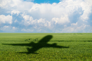 Shadow of the plane on the agricultural field. Concept of decarbonization and biofuel	