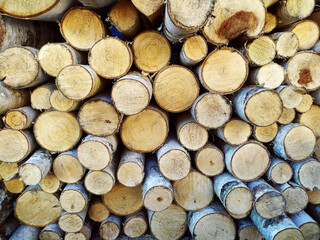 Photo of stacks of logs made of natural wood. Background. Harvesting firewood for the winter. Heated houses. Texture. Firewood for the fireplace. Birch boards. Macrosymka. Copy space