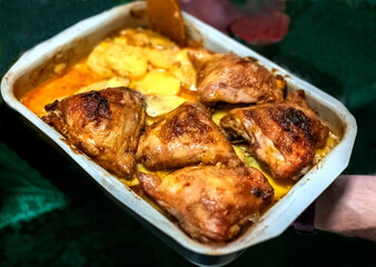 Pieces of baked chicken with potatoes in the form of a close-up
