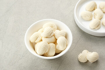 Meringue cookies in white bowl, made from whipped flour with sugar and eggs
