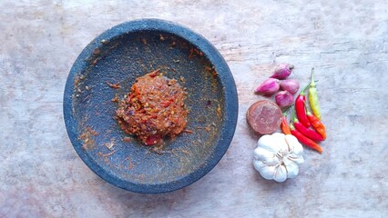 Sambal is a spicy traditional food from Indonesia made from chillies. Sambal on wood background