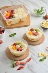Fresh Fruit Salad made of strawberries, grapes, longan and apple and grated cheese
