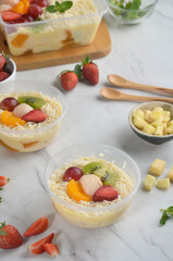 Fresh Fruit Salad made of strawberries, grapes, longan and apple and grated cheese
