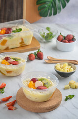 Fresh Fruit Salad made of strawberries, grapes, longan and apple and grated cheese
