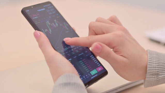 Woman Checking Trading Charts on Smartphone, Close Up