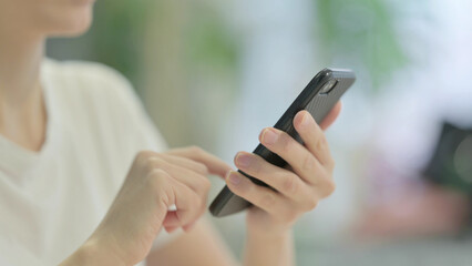 Close up of Casual Young Woman Browsing Internet on Smartphone
