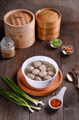 Chinese meatball soup are made of beef or pork of fish isolated on wooden background
