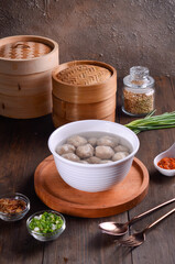 Chinese meatball soup are made of beef or pork of fish isolated on wooden background
