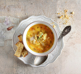 pea soup with croutons in a white vintage bowl, on a beige background