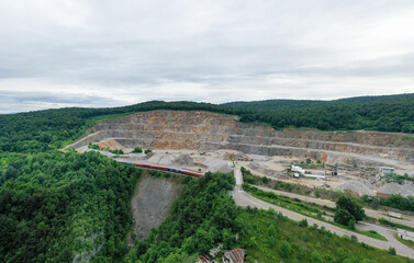 Stone Quarry in Croatia, Europe. Aerial View of Opencast Mining Quarry With Lots of Machinery. View from Above. Marble Mining Industry