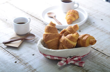 A croissant is a buttery, flaky pastry with yeast-leavened laminated dough isolated on white backhground
