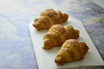 A croissant is a buttery, flaky pastry with yeast-leavened laminated dough isolated on white backhground
