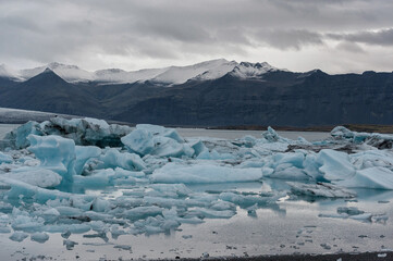 Jokulsarlon Glacier Lagoon and Mountain in Background. Lots of Ice Peaces in Water.