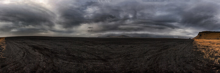 Black Sand Desert in Iceland. Panorama Photo. Cloudy Sky. Hjorleifshofdi.