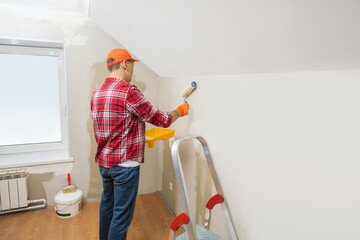 man painting wall with roller. banner with place for text.