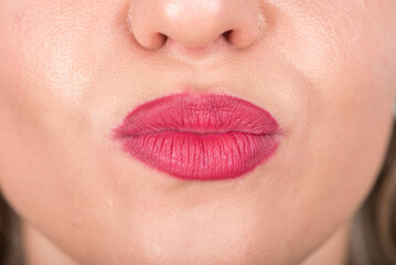 Woman Face and Kiss Symbol with Lips. Studio Photo Shoot. Use Bright Red Lipstick.