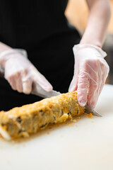 professional chef's hands making sushi and rolls in a restaurant kitchen