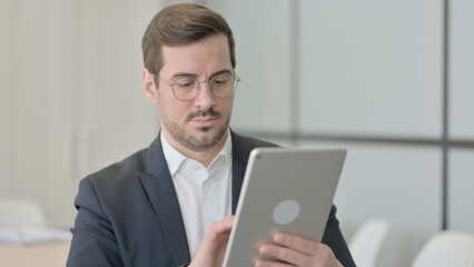 Businessman Browsing Internet on Digital Tablet