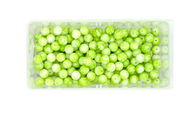 isolate cut close-up green beads, selective focus with blur effect, background for handicrafts and jewelry, DIY jewelry beads. transparent container