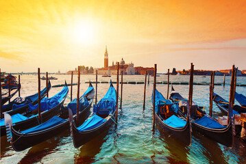 Magic cityscape with gondolas  on the San Marco canal on the background of  Church of San Giorgio Maggiore at sunset in Venice, Italia, Europe.